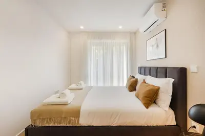 a bedroom with a bed with two towels on it at GuestReady - Gracious City Escape in Porto in Porto