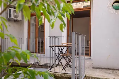 a table on the porch of a house at Cool Alegria 1 Bed Studio Retreat in Bicas