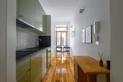 a kitchen with a wooden floor and a wooden table at Cool Alegria 1 Bed Studio Retreat in Bicas