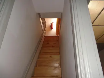 a stairway leading to a room with a red fire hydrant at Portuense Alojamento Local in Porto