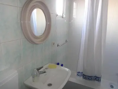 a bathroom with a sink and a mirror at Portuense Alojamento Local in Porto
