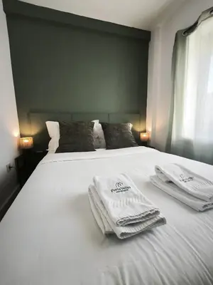 a white bed with towels on top of it at Best Deal Porto Apartment - Porto Velho Apt in Porto
