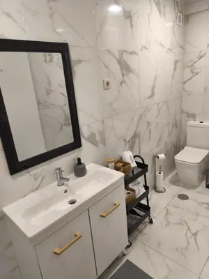 a white bathroom with a sink and a mirror at Best Deal Porto Apartment - Porto Velho Apt in Porto