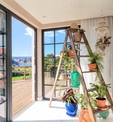a ladder shelf with plants on a porch at Quinta de Sá in Vila Nova de Gaia
