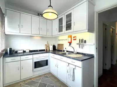 a white kitchen with white cabinets and a sink at Your house in Porto in Vila Nova de Gaia