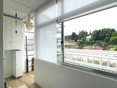 an empty room with a large window with a view at Your house in Porto in Vila Nova de Gaia