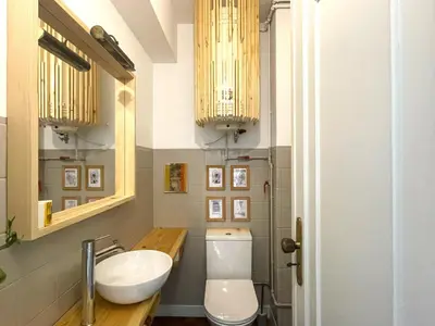 a bathroom with a toilet and a sink and a mirror at Your house in Porto in Vila Nova de Gaia