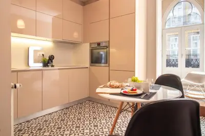 a small kitchen with a table and chairs at Cardosas Bright Studio by LovelyStay in Porto