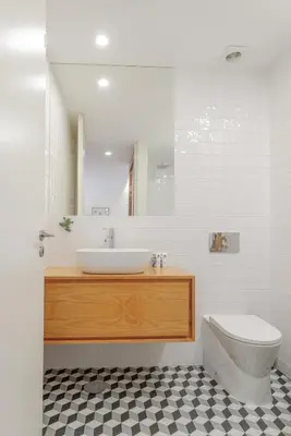 a bathroom with a sink and a toilet and a mirror at Lovely & Centre Flat with Terrace by HostWise in Porto