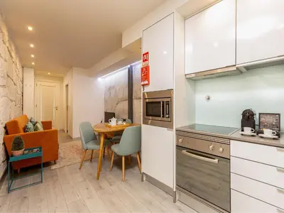 a kitchen and dining room with a table in a room at Apartment with Balcony for 4 Guests in Porto