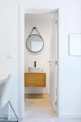 a bathroom with a sink and a mirror at Bright Flat | Romantic Escape by HostWise in Porto