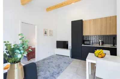 a living room with a table and a kitchen at Bright Flat | Romantic Escape by HostWise in Porto