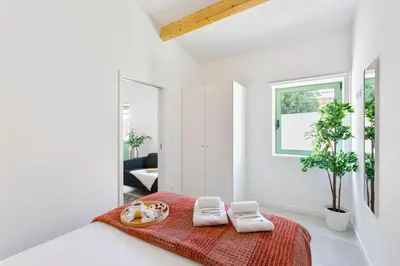 a white room with a bed with a red blanket at Bright Flat | Romantic Escape by HostWise in Porto