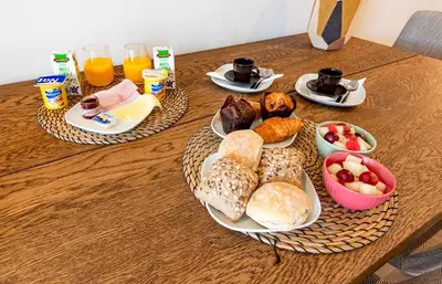 two plates of food on a table with breakfast foods at NorteSoul OldTown - 2 Bedroom 2 Bathroom Apartment! in Porto