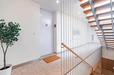 a staircase in a house with white walls and a glass door at NorteSoul OldTown - 2 Bedroom 2 Bathroom Apartment! in Porto