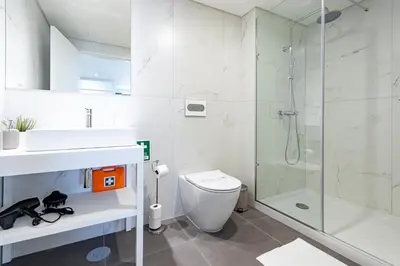 a bathroom with a shower and a toilet and a sink at NorteSoul OldTown - 2 Bedroom 2 Bathroom Apartment! in Porto