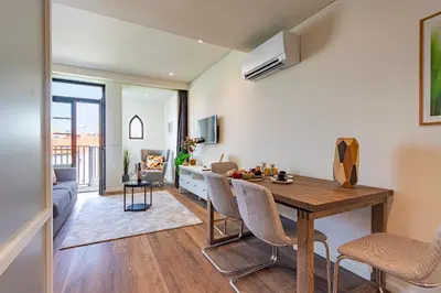 a kitchen and living room with a wooden table and chairs at NorteSoul OldTown - 2 Bedroom 2 Bathroom Apartment! in Porto