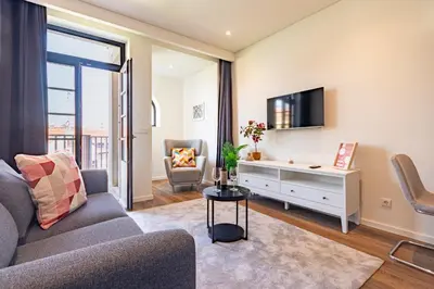 a living room with a couch and a tv at NorteSoul OldTown - 2 Bedroom 2 Bathroom Apartment! in Porto