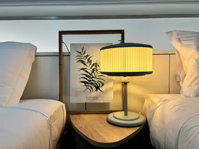 a lamp sitting on a table between two beds at AC, 2Bedrooms APT, City Center 900m to Metro in Porto