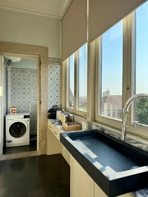 a kitchen with a sink and a washing machine at Alegria Vintage Apartments - Porto in Porto