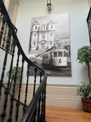 a staircase with a picture of a train on the wall at Alegria Vintage Apartments - Porto in Porto