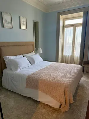 a bedroom with a large white bed with a window at Alegria Vintage Apartments - Porto in Porto