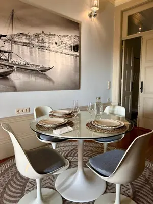 a dining room with a glass table and chairs at Alegria Vintage Apartments - Porto in Porto