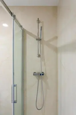 a shower with a shower head in a bathroom at Modern & Central Flat w/ Garage by HostWise in Porto