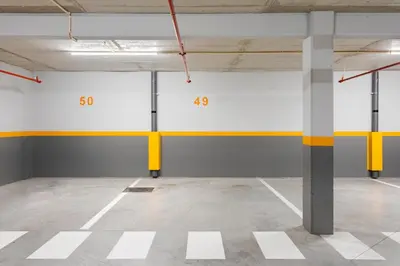 an empty parking garage with yellow and white walls at Modern & Central Flat w/ Garage by HostWise in Porto