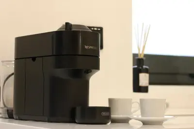 a coffee machine sitting on a counter with cups at Lapa 4 House in Porto