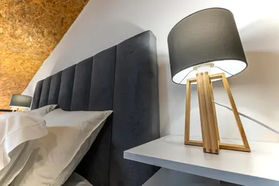 a lamp on a table next to a bed at Lapa 4 House in Porto