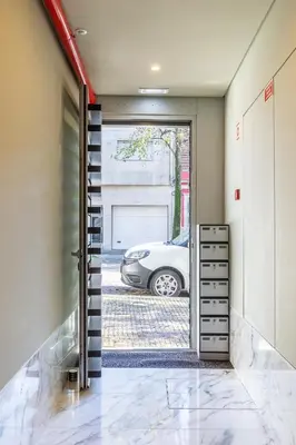 a car is parked in a garage through a door at Urban Oasis Six Suites Apts Porto in Porto