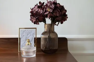a vase with purple flowers in it next to a picture at Sa Bandeira Signature Apartment in Porto
