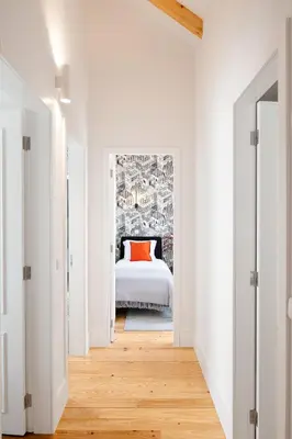 a white bedroom with a bed with an orange pillow at 89 T3 - Flores Gem in Porto