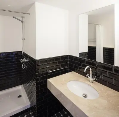 a bathroom with a sink and a mirror and a tub at Oporto Serviced Apartments - Cedofeita in Porto