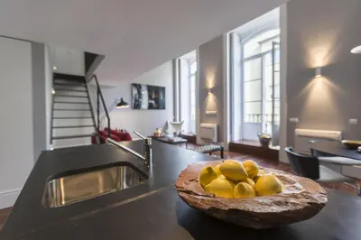 a kitchen with a bowl of fruit on a counter at Oporto Serviced Apartments - Cedofeita in Porto