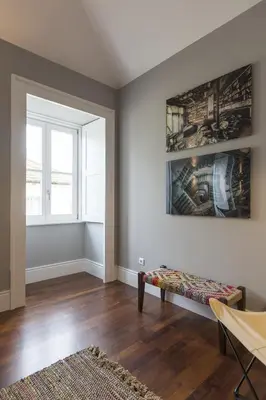 an empty living room with a bench and a window at Oporto Serviced Apartments - Cedofeita in Porto