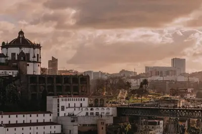 a view of a city with buildings and a bridge at LENSCAPE Coterie in Porto