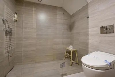 a bathroom with a toilet and a glass shower at Garden Luxury House Downtown Oporto with AC in Porto