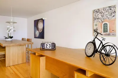a bike on a wooden table in a room at Garden Luxury House Downtown Oporto with AC in Porto