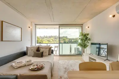 a living room with a couch and a table at Premium Apartments with Balcony, Pool & Garage by HostWise in Vila Nova de Gaia
