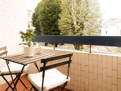 a table and chairs on a balcony with a window at Fonsi House in Porto