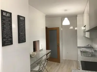a kitchen with a counter top and a table at Fonsi House in Porto
