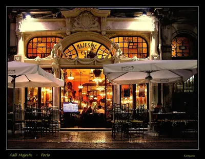 a restaurant with tables and chairs and umbrellas at Fonsi House in Porto