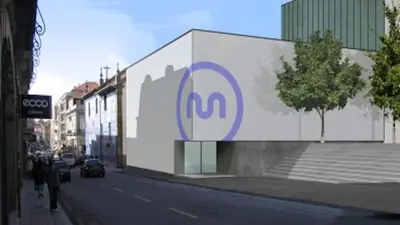 a building with a sign on the side of a street at Quiet Studio City Center in Porto