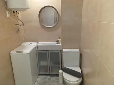 a bathroom with a toilet and a sink and a mirror at Quiet Studio City Center in Porto