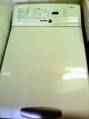 a close up of a washing machine with a remote control at Quiet Studio City Center in Porto