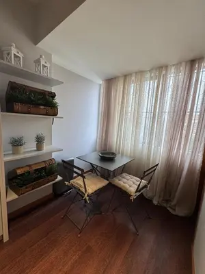 a table and chairs in a room with a window at Casa da Música Apartment in Porto