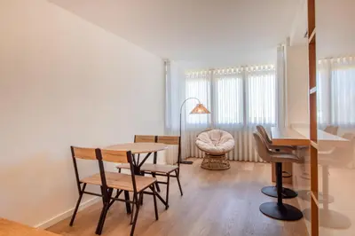 a kitchen and dining room with a table and chairs at Peaceful 1BR Near Metro by LovelyStay in Porto