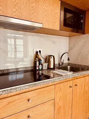 a kitchen with a sink and a microwave at Porto Old Town Escape in Porto